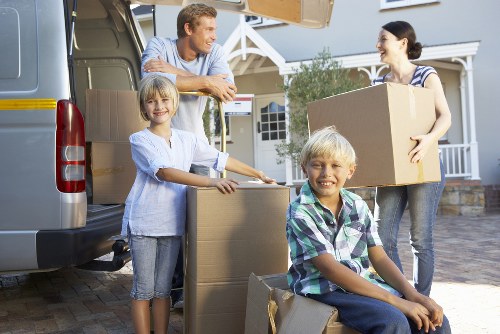 Local removal team carrying furniture through a Bloomsbury property