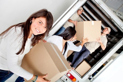 Professional man and van transporting furniture in central London